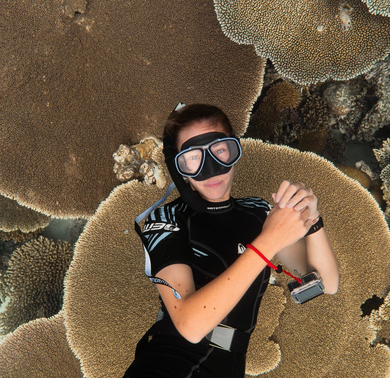 Marine biologist Jess Hodge underwater among coral